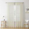 A pair of sheer white voile curtains hanging in a window frame.
