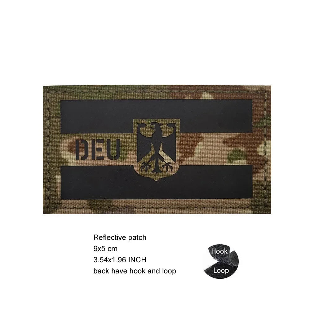 A dark rectangular reflective patch featuring the German eagle symbol on a black background.