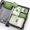 A set of six olive green and beige travel packing cubes inside a gray storage case.