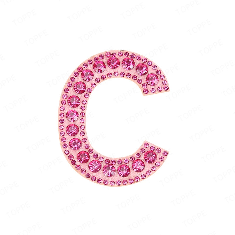 A pink rhinestone letter C patch with a glittery finish.