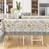 Elegant floral tablecloth with embossed edges displayed on a wooden table.