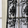 Black sheer curtain featuring intricate lace embroidery with pearl accents.