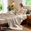 A beige pure French linen bed sheet draped over a bed in a bright room.