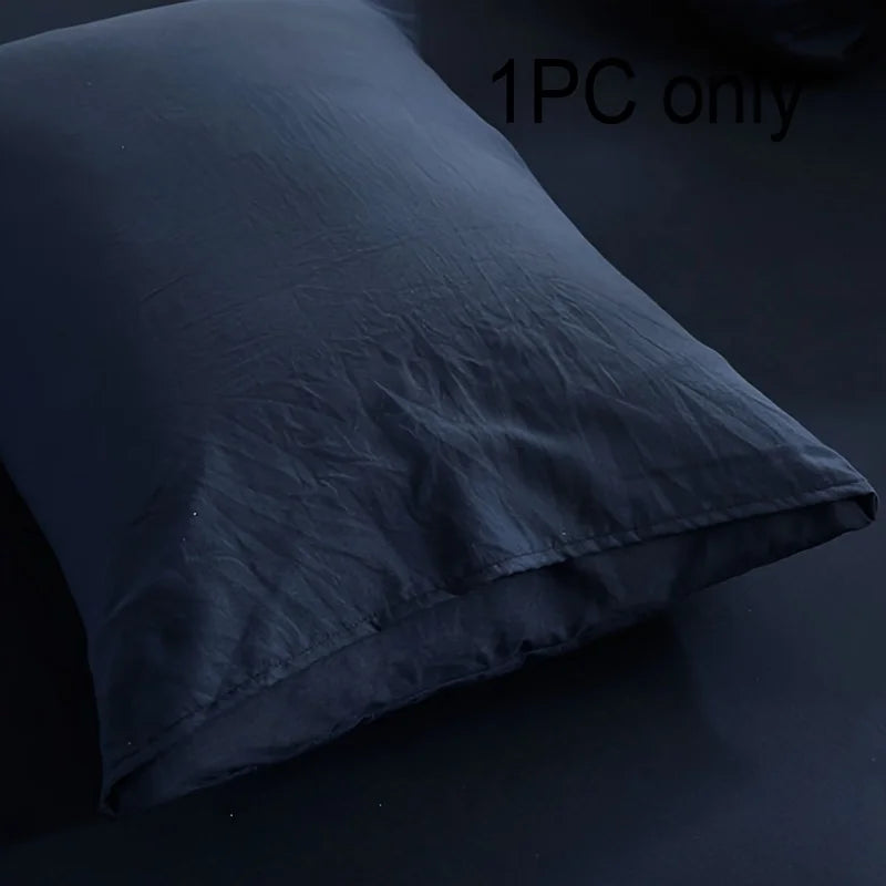 A dark gray or black brushed cotton pillowcase with an envelope closure shown in a close-up view.