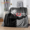 A black and white vintage-inspired graphic throw blanket featuring a portrait of a man in a suit.