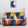 A vibrant stretch floral elastic sofa cover featuring a geometric pattern of blue, yellow, orange, and red colors.