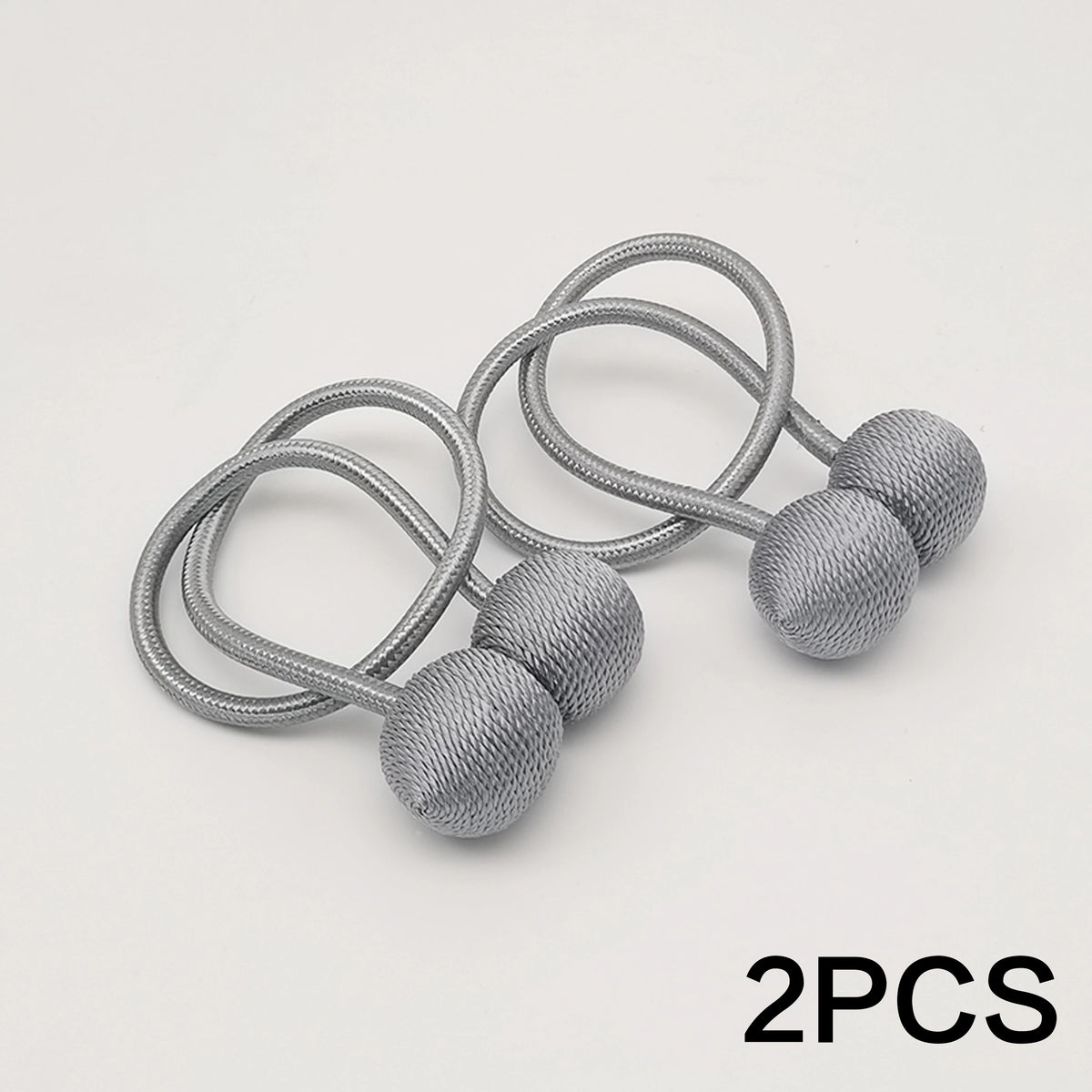 Two silver minimalist magnetic ball curtain tiebacks with coiled wire designs.