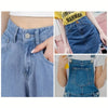 Close-up of a denim skirt showing adjustable metal snap buttons and details.