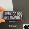 A black and red embroidered patch with the text Service Dog in Training