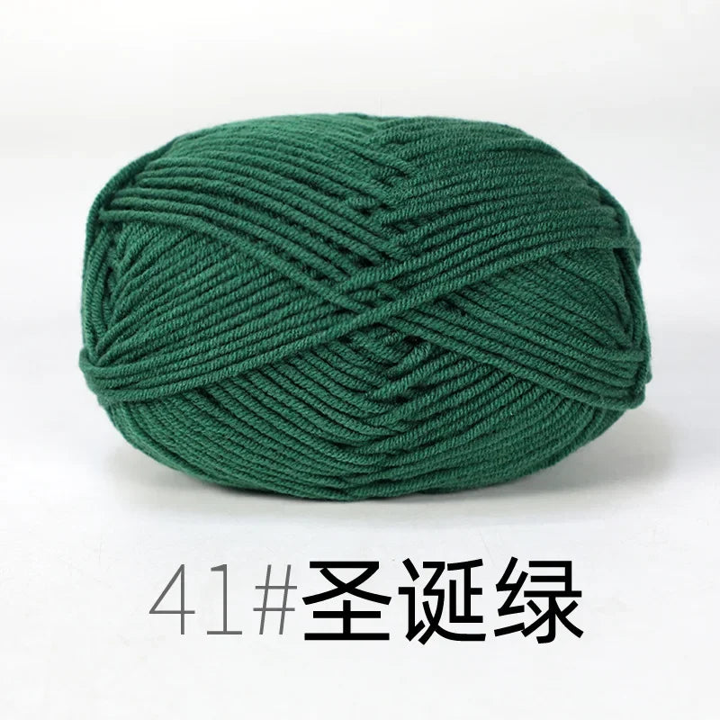 A ball of dark green organic cotton 4ply knitting yarn for crafts.