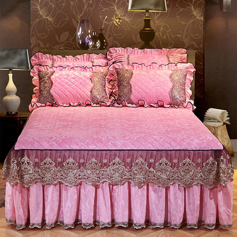 Pink quilted bed skirt set with ruffled pillowcases and lace trim