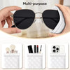 A hand holds a black sunglasses case with a white quilted PU leather exterior and a cleaning cloth.