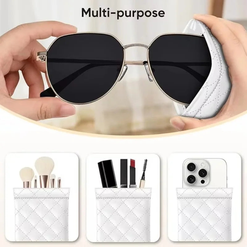 A hand holds a black sunglasses case with a white quilted PU leather exterior and a cleaning cloth.