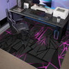 A black gaming desk setup featuring a neon hexagon area rug with pink and blue accents.