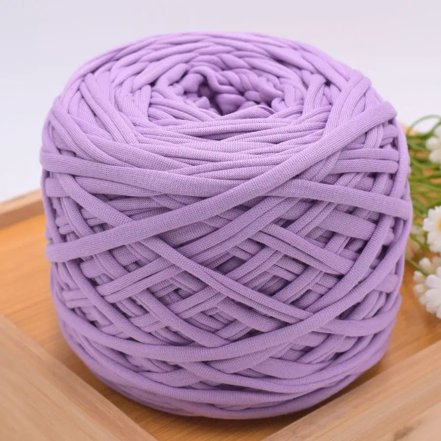 A ball of purple craft yarn made of 100% polyester for knitting and DIY projects.