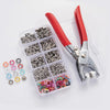 A precision snap fastener kit with red handles and clear storage compartments is shown on a white surface.