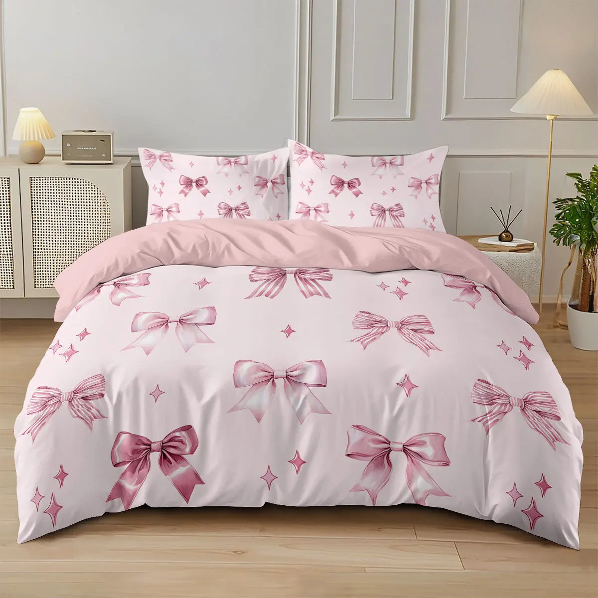 A pink bow printed duvet cover set featuring pink and white floral patterns on a bed.