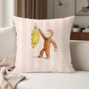 A decorative pillow cover featuring an illustration of a monkey character holding a banana on a striped pink background.