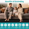 A man and a woman sitting on a couch enjoying a moment, illustrating the benefits of grounding.