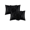 A stack of black satin pillowcases for soft, breathable sleep.