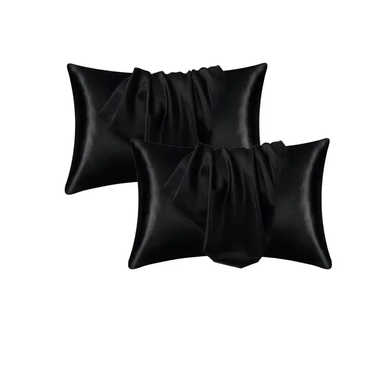 A stack of black satin pillowcases for soft, breathable sleep.