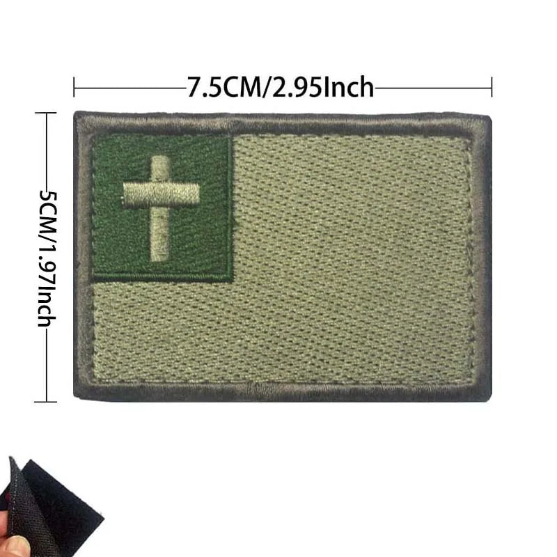 A rectangular embroidered patch featuring a cross symbol on a green flag background.