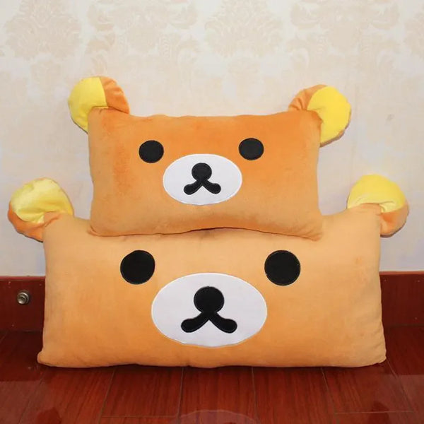A pair of Rilakkuma plush bed pillows and sofa cushions in orange and yellow colors.