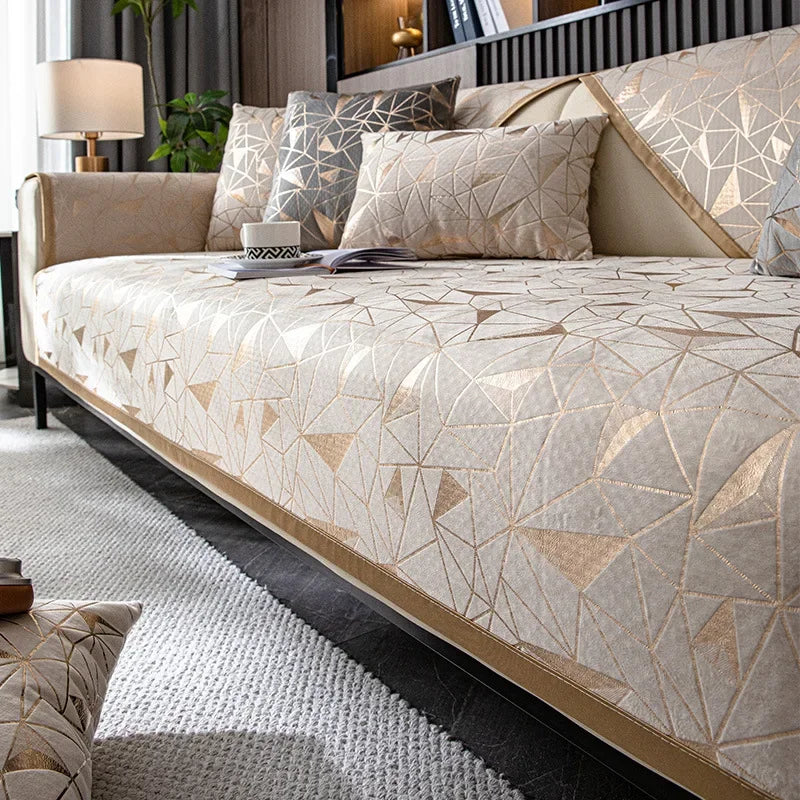 A luxury chenille sofa cover featuring a geometric pattern in beige and gold tones on a modern sofa.
