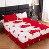 A set of three red and white fitted bed sheets with elastic lace trim displayed on a bed.