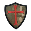 A dark olive green shield patch embroidered with a red cross and black border.