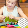 A young girl is using a stainless steel sewing needle to thread fabric for a craft project.