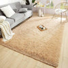A fluffy beige shag rug placed on a light wood floor in a modern living room setting.