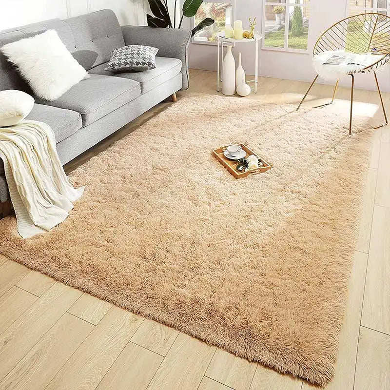 A fluffy beige shag rug placed on a light wood floor in a modern living room setting.