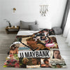 A dark patterned throw blanket featuring portraits and text on a light gray background.