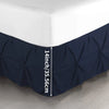 Navy blue premium wrap-around bed skirt shown against a white wall, displaying the 14 inch height measurement.