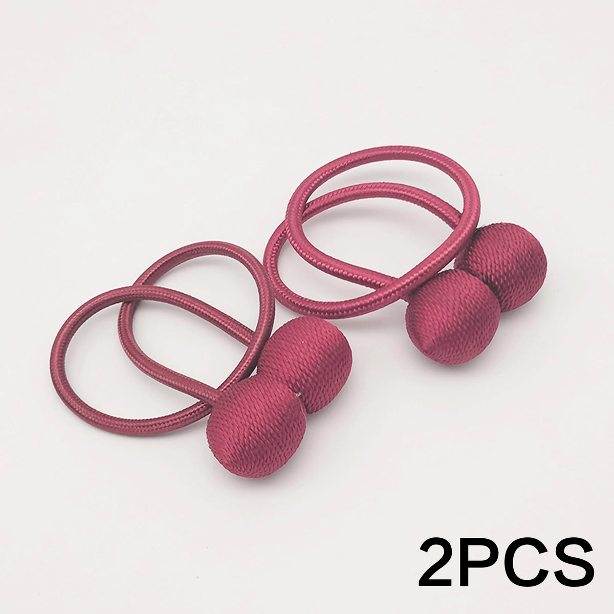 Two pink magnetic ball curtain tiebacks with thin elastic loops