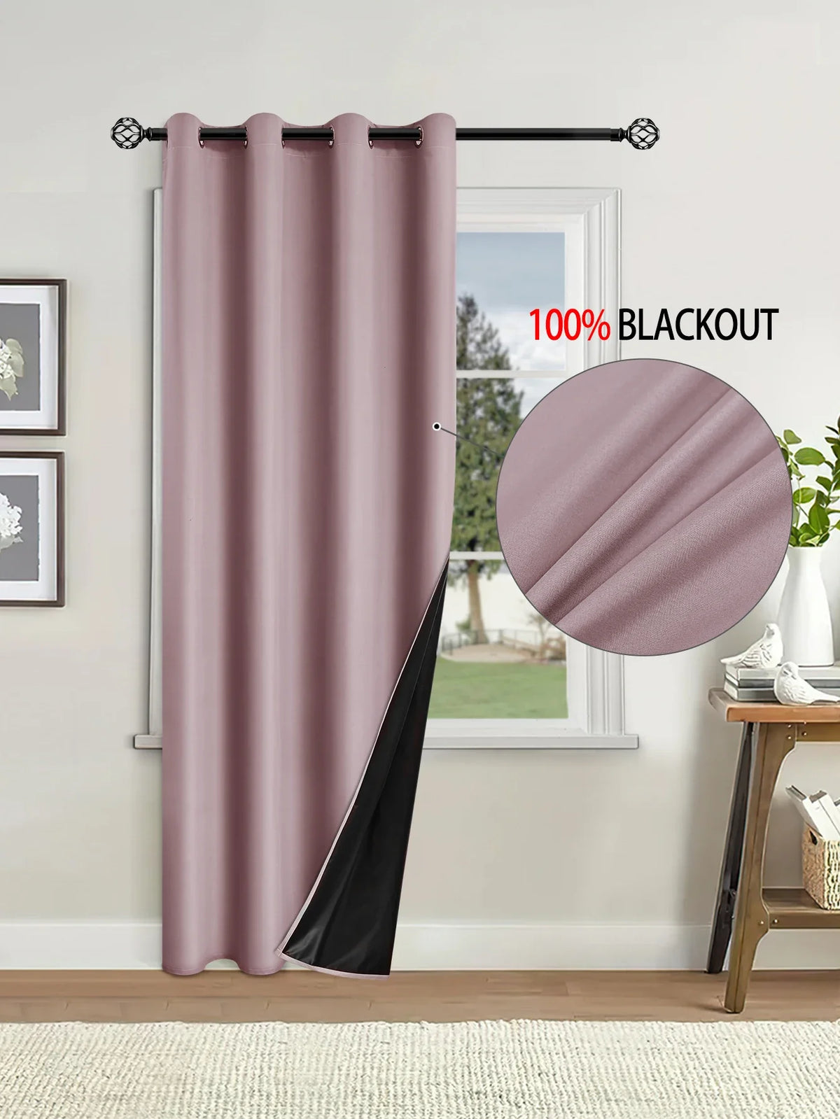 A floor-length mauve blackout curtain hanging on a rod next to a window.