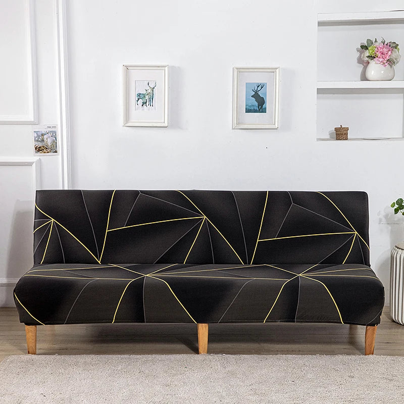 Black spandex slipcovers with a geometric gold print on a sofa bed.