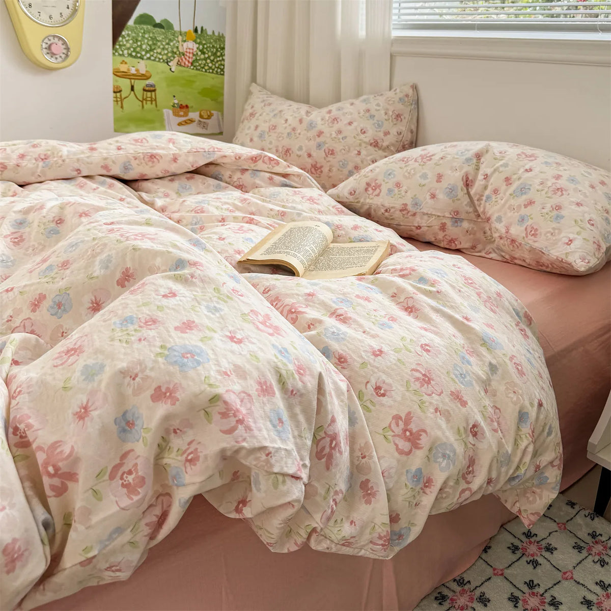 A pink floral microfiber duvet set with light pink and green patterns is displayed on a bed.