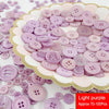 Assorted resin sewing buttons in light purple and pink shades arranged on a white plate.