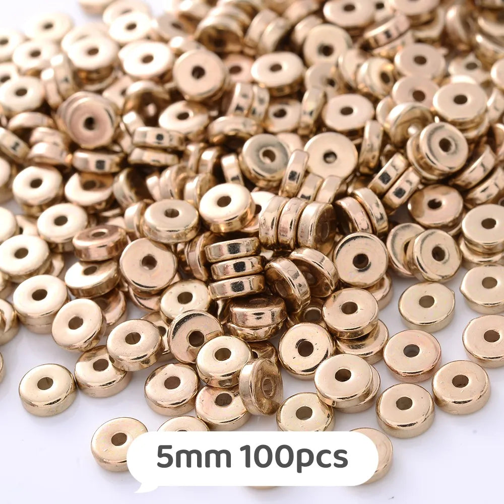 A pile of small gold-colored geometric acrylic beads for jewelry making