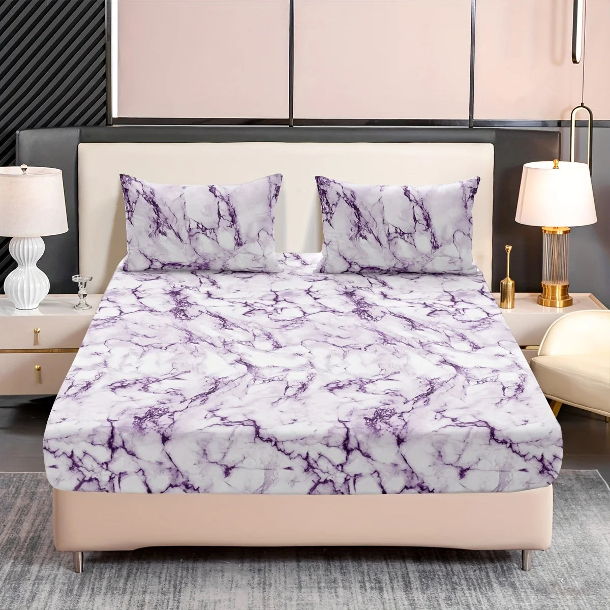 A bed dressed with a white and purple marble print fitted sheet set and matching pillowcases.