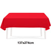 A bright red rectangular tablecloth displayed on a white table.