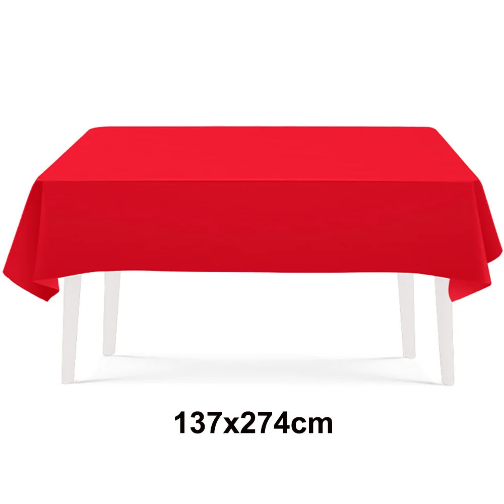 A bright red rectangular tablecloth displayed on a white table.
