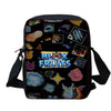 A black cartoon kids backpack set featuring various fruit designs and a matching shoulder bag.