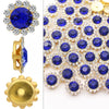 Close-up of blue and clear crystal rhinestone sunflower buttons and a gold sew-on component.