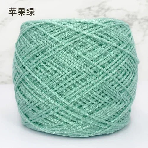 A ball of light mint green metallic silk yarn used for crocheting and knitting.