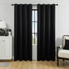 Solid black blackout window curtains hanging in a window frame.