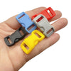 A hand holds several colorful adjustable plastic paracord buckle bracelets in various shades of red, blue, gray, and yellow.
