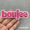 Pink embroidered patch with the word boujee on a hand